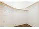 Spacious walk-in closet with wood shelving and neutral carpet at 11204 Newbury Hills Ave, Las Vegas, NV 89138