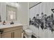 Well-lit bathroom with a stylish vanity and a unique shower curtain at 11705 Bearpaw Meadow Ave, Las Vegas, NV 89138
