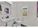 Stylish powder room featuring a pedestal sink, and modern fixtures at 11705 Bearpaw Meadow Ave, Las Vegas, NV 89138