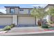 Contemporary home exterior featuring a two-car garage and manicured landscaping at 11705 Bearpaw Meadow Ave, Las Vegas, NV 89138