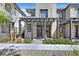 Contemporary two-story home with a decorative pergola, stone accents, and stylish front yard landscaping at 11705 Bearpaw Meadow Ave, Las Vegas, NV 89138