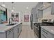 Modern kitchen with stainless steel appliances, stone countertops, and an open design perfect for entertaining guests at 11705 Bearpaw Meadow Ave, Las Vegas, NV 89138