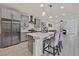 Open kitchen featuring stainless steel appliances, an island with seating, and a seamless flow into the living area at 11705 Bearpaw Meadow Ave, Las Vegas, NV 89138