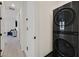 Hallway featuring a stacked LG washer and dryer with access to a light-filled room at 11705 Bearpaw Meadow Ave, Las Vegas, NV 89138
