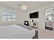 Sunlit main bedroom features a TV, and a modern ensuite bathroom at 11705 Bearpaw Meadow Ave, Las Vegas, NV 89138