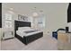 Elegant main bedroom with a plush bed, mirrored nightstands, and ample natural light at 11705 Bearpaw Meadow Ave, Las Vegas, NV 89138
