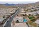 Scenic aerial view showcases neighborhood homes, serene streets, and a beautiful pool with mountain views at 12346 Valley Chase Ave, Las Vegas, NV 89138