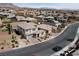 Expansive aerial shot showcasing neighborhood homes with mountain views and a quiet residential street at 12346 Valley Chase Ave, Las Vegas, NV 89138