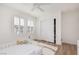 Bright bedroom features wood floors, shuttered windows, and a cozy crib at 12346 Valley Chase Ave, Las Vegas, NV 89138