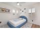 Bedroom features a blue bed, plush carpeting and bright natural light from the window at 12346 Valley Chase Ave, Las Vegas, NV 89138
