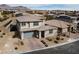 Aerial view of a modern two-story home with desert landscaping and a two-car garage at 12346 Valley Chase Ave, Las Vegas, NV 89138