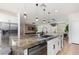 Gourmet kitchen with a large island, granite countertops, and wood-look flooring at 12346 Valley Chase Ave, Las Vegas, NV 89138