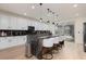 Modern kitchen featuring a large island, stylish bar stools, and stainless steel appliances at 12346 Valley Chase Ave, Las Vegas, NV 89138