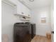 Laundry room featuring full-sized machines, storage cabinets, and a window with natural light at 12346 Valley Chase Ave, Las Vegas, NV 89138
