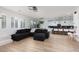Bright and open living space with a modern sectional sofa and wood-look floors at 12346 Valley Chase Ave, Las Vegas, NV 89138