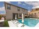 Backyard pool and spa with tanning ledge, lounge chairs, and artificial grass at 12346 Valley Chase Ave, Las Vegas, NV 89138