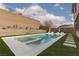 Backyard pool and spa with a tanning ledge and lounge chairs at 12346 Valley Chase Ave, Las Vegas, NV 89138