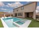 Backyard pool with tanning ledge and artificial grass, perfect for relaxation at 12346 Valley Chase Ave, Las Vegas, NV 89138