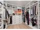 Spacious walk-in closet with custom shelves, hanging racks, and built-in drawers for storage at 12346 Valley Chase Ave, Las Vegas, NV 89138