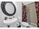 Bathroom featuring a pedestal sink and tiled shower at 1589 Silver Mesa Way, Las Vegas, NV 89169
