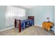 Bedroom featuring a dark wood bed frame and a bright blue quilt at 1589 Silver Mesa Way, Las Vegas, NV 89169