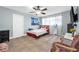 Comfortable bedroom featuring ceiling fan, tile floors, and large window at 1589 Silver Mesa Way, Las Vegas, NV 89169