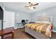 The bedroom has tile floors, ceiling fan, and neutral tones at 1589 Silver Mesa Way, Las Vegas, NV 89169