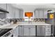Modern kitchen featuring gray cabinets, stainless steel appliances, and a stylish backsplash at 1589 Silver Mesa Way, Las Vegas, NV 89169