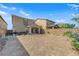 Wide backyard featuring pavers and a covered patio with outdoor seating at 1606 Wild Grain Ave, North Las Vegas, NV 89086
