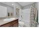 Bright bathroom featuring a tub/shower combination with stylish fixtures and decorative shelving at 1606 Wild Grain Ave, North Las Vegas, NV 89086