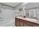 Bathroom boasts double sinks, sleek fixtures, and a shower over tub at 1606 Wild Grain Ave, North Las Vegas, NV 89086
