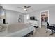 Spacious bedroom features a ceiling fan, dresser with TV, and a walk-in closet at 1606 Wild Grain Ave, North Las Vegas, NV 89086