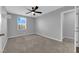 Neutral bedroom with carpet flooring, ceiling fan, and good window light at 1606 Wild Grain Ave, North Las Vegas, NV 89086