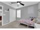 Comfortable bedroom with a twin bed, closet, window, and soft, neutral decor at 1606 Wild Grain Ave, North Las Vegas, NV 89086