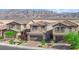 Two-story home featuring desert landscaping, a two-car garage and brick paved driveway at 1606 Wild Grain Ave, North Las Vegas, NV 89086