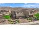 Two-story home featuring desert landscaping, a two-car garage and brick paved driveway at 1606 Wild Grain Ave, North Las Vegas, NV 89086