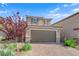 Charming two-story home featuring a tiled roof, a two-car garage, and a brick driveway at 1606 Wild Grain Ave, North Las Vegas, NV 89086