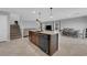 Open-concept kitchen with a large island and breakfast bar, seamlessly connecting to the living and dining areas at 1606 Wild Grain Ave, North Las Vegas, NV 89086