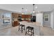 Well-equipped kitchen with an island, granite countertops, wood cabinets, and stainless steel appliances at 1606 Wild Grain Ave, North Las Vegas, NV 89086