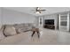 Bright living room with neutral tones, large windows, tile floors, and a comfortable seating area at 1606 Wild Grain Ave, North Las Vegas, NV 89086