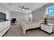 Bright main bedroom offering a peaceful retreat with two windows, carpet floors, and soft lighting at 1606 Wild Grain Ave, North Las Vegas, NV 89086