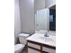 Bathroom with a single sink vanity, framed mirror, and white toilet at 1655 Morse Arberry Ave, Las Vegas, NV 89106