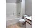 Well-lit bathroom features a shower and bathtub combination with tile surround at 1655 Morse Arberry Ave, Las Vegas, NV 89106