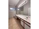 Bathroom featuring double sinks, tile floors, ample counter space, and natural lighting at 1655 Morse Arberry Ave, Las Vegas, NV 89106