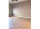 Neutral bedroom featuring tile floors, baseboards and ample wall space for decor at 1655 Morse Arberry Ave, Las Vegas, NV 89106