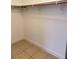 Walk-in closet featuring tile floors, baseboards, wooden rod, and shelving at 1655 Morse Arberry Ave, Las Vegas, NV 89106