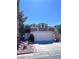 Two-story home with a two car garage and landscaped front yard under a clear blue sky at 1655 Morse Arberry Ave, Las Vegas, NV 89106