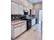 Kitchen view featuring white cabinets, black appliances, and tile backsplash at 1655 Morse Arberry Ave, Las Vegas, NV 89106