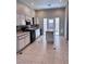 Well-lit kitchen features black appliances, white cabinets, and a center island at 1655 Morse Arberry Ave, Las Vegas, NV 89106