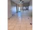 Inviting living room with neutral color scheme, tile flooring and a glass block wall at 1655 Morse Arberry Ave, Las Vegas, NV 89106
